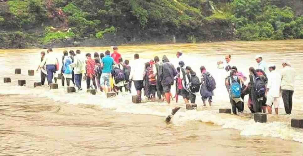 Sangamner Students walk through the water from the embankment 