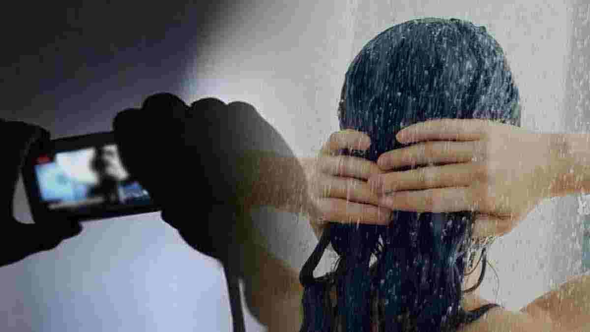 Take a pornographic video of a woman taking a shower from the bathroom